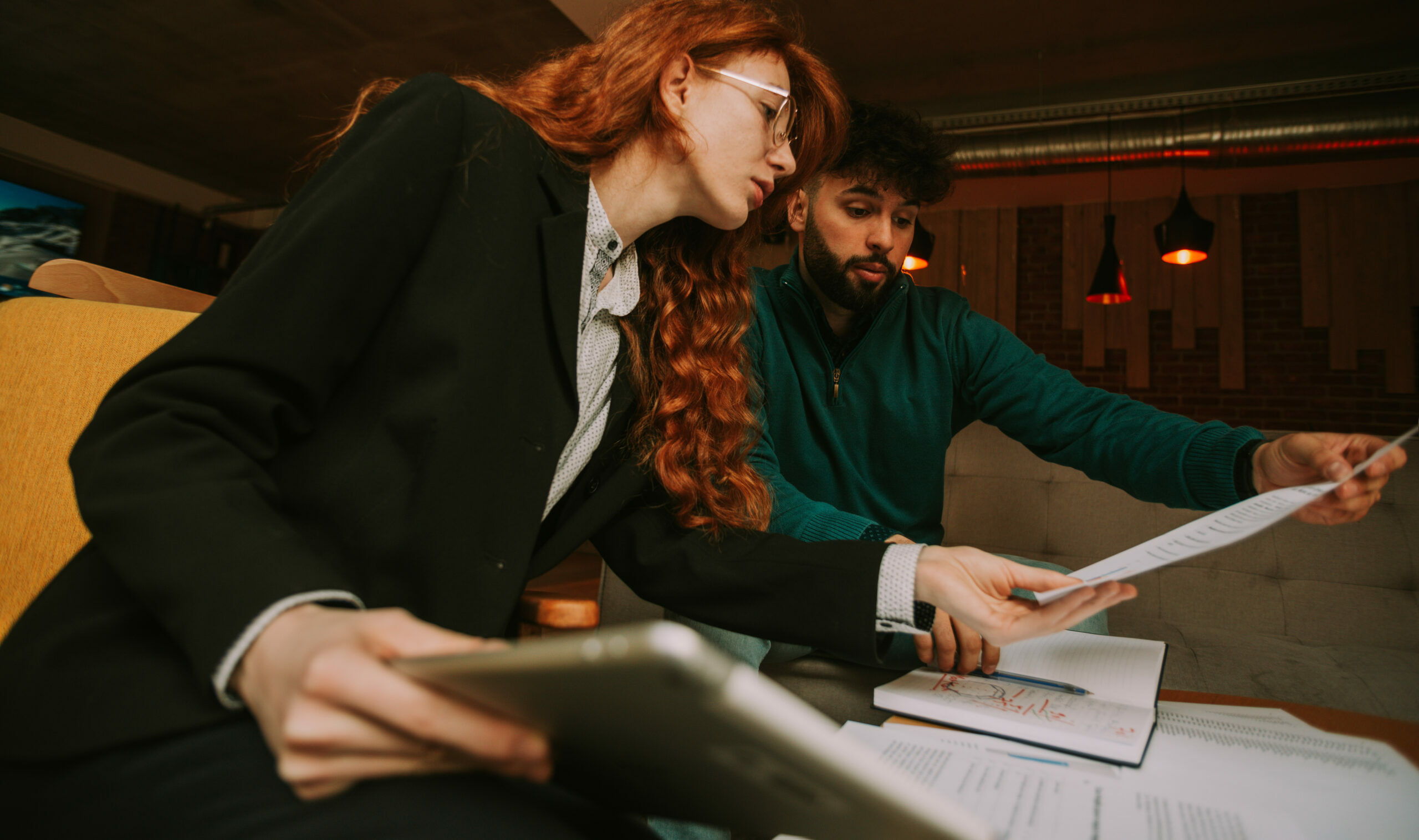 Young Ginger Businesswoman Checking Her Male Colleague New Deal